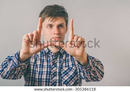 man making frame with his hands on white background