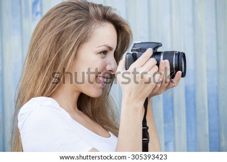 Portrait of smiling young beautiful girl taking a photo