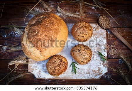 fresh bread and wheat on the wooden table