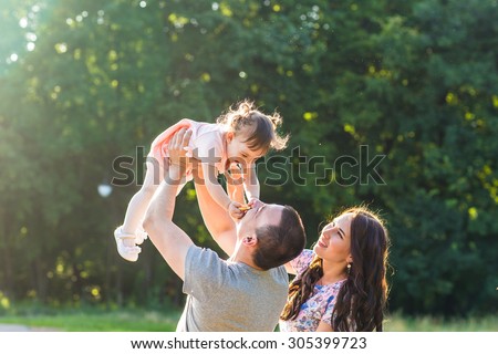 Happy Young Mixed Race Ethnic Family Walking In The Park. Royalty-Free Stock Photo #305399723