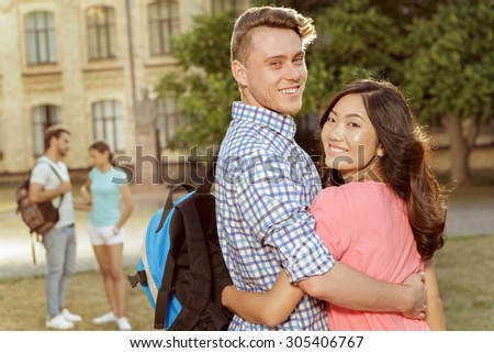 Funny carefree students walk in the park