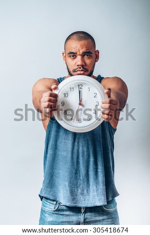 young crazy man with a clock