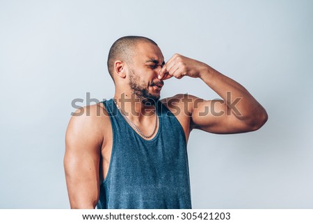 man closes nose hand