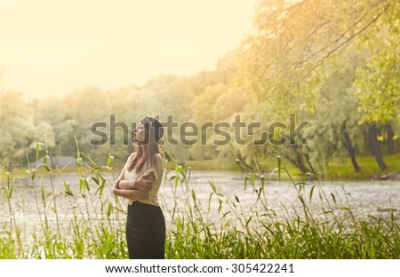 Golden hour sunny picture with a beautiful girl in the nature