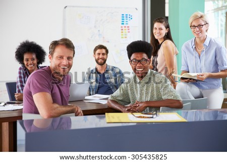 Portrait Of Businesspeople Having Creative Meeting In Office