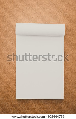 White paper mock up on wood background - vintage filter