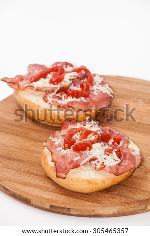 Sandwiches with ham, grated cheese and ketchup.