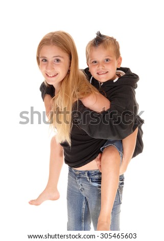 A closeup picture of a young girl caring her little brother on her back,
smiling, isolated for white background.

