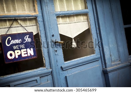 Open sign on the door of an old pub
