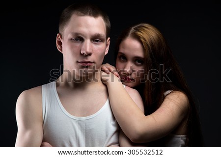 Photo of boy and brunette girl on black background