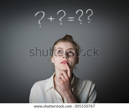 Girl in white full of doubts and hesitation. Girl and question marks above her head. Young slim woman. 