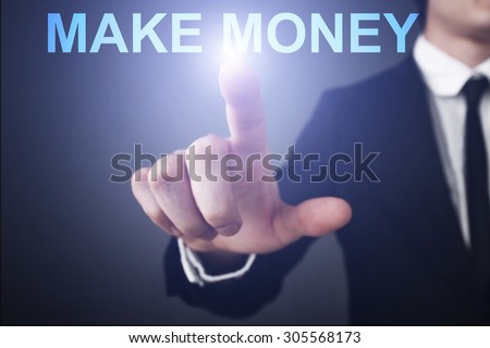 Businessman pressing button on virtual touch screen  and select "make money". Business concept. Internet concept.
