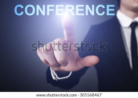 Businessman pressing button on touch screen interface and select "Conference". Business concept. Internet concept.
