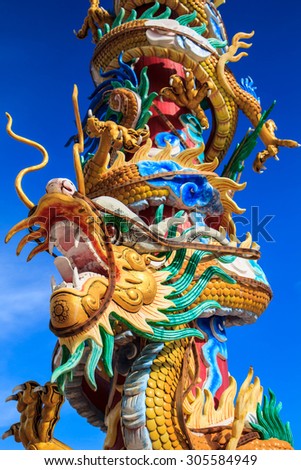 Chinese style dragon statue and blue sky in Chinese temple,Thailand ( Generality in Thailand ,and kind of art decorated in Buddhist church, temple pavilion ,temple hall . They are public)