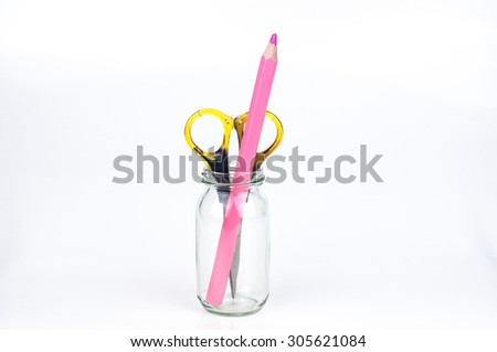 Scissor, color pencil and glass jar on white background
