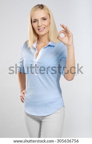 Smiling woman with okay gesture