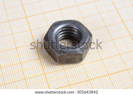 Screw, Nuts and caliper on  graph paper background