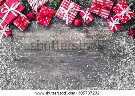 Christmas background with decorations and gift boxes on wooden board Royalty-Free Stock Photo #305737232