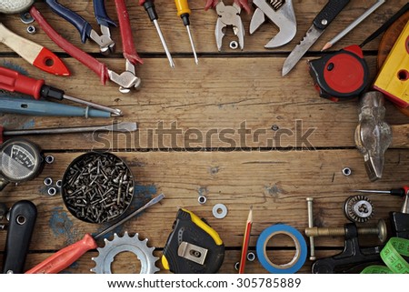        Tools on a timber floor, the top view. Tools are spread out round a blank space for your text.                        