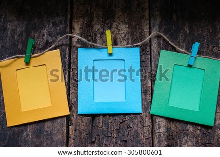 photo frames on a rope on a wooden background