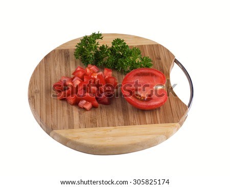 Tomato sliced on a circular wooden board  isolated. 