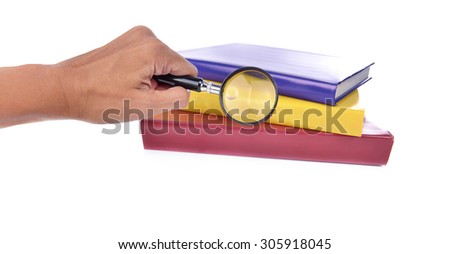 books and hand hold the magnifying glass. room for text. Symbol of knowledge and science