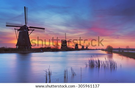 Traditional Dutch windmills with a colourful sky just before sunrise. Photographed at the famous Kinderdijk.