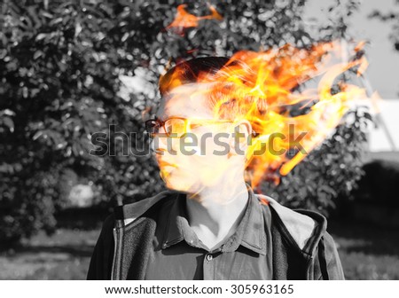 Double exposure effect on the photo with young man and fire