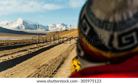A traditionally woven bolivian hat and the great altiplano landscape with a selective focus