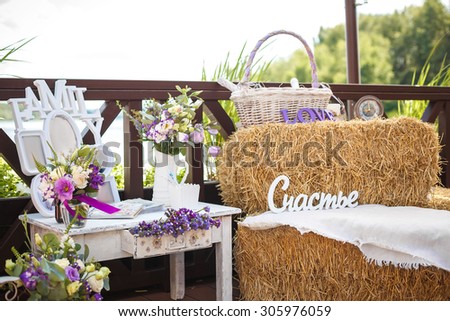 fotozona in the style of Provence at the wedding. hay and flowers in the decor. The Russian word ??????? - translation is   happiness