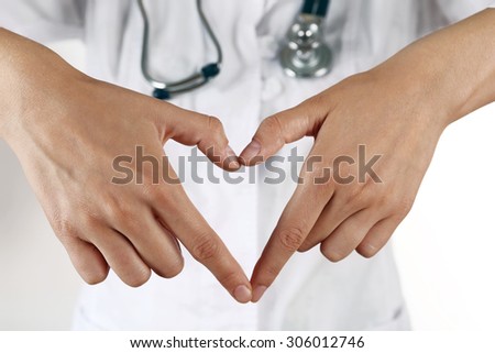 Doctor's hands making heart shape close up