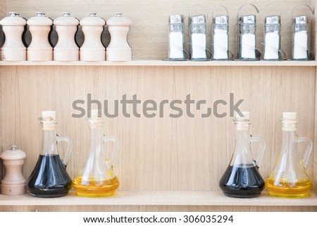 Color picture of oil and vinegar containers and a salt grinders and shakers