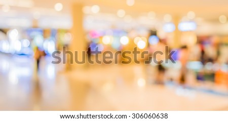 blurred image of shopping mall and people .