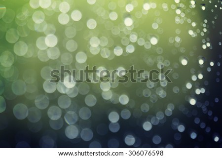 Blurry background image made of water droplets in the window glass. This image is suitable for example for text backgrounds, website backgrounds, or anything else. Image has a vintage effect.