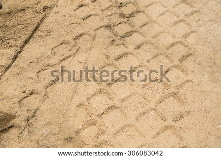 Detail of tyre tracks in sand on building bridge