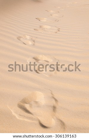 Footprints of gone man in sand