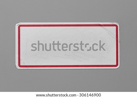 Label Adhesive with Dirt and Scratches Close Up on Grey Background with Real Shadow. Top View of Adhesive Paper Tag with Red Border. Stickers with Copy Space for Text or Image