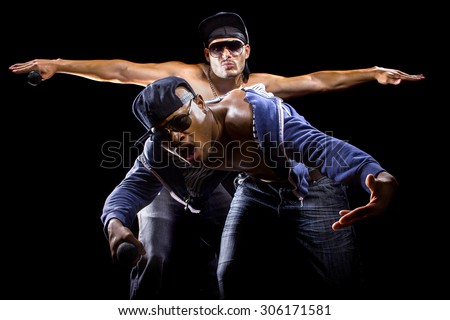Rap concert with two muscular shirtless men with microphones.  The musicians are hip hop artists. Royalty-Free Stock Photo #306171581