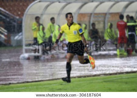 blurry Assistant football referee and Referee's flag