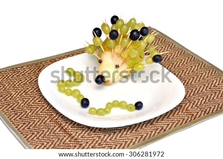 Funny figure hedgehog and caterpillars of fruit for children food, made by a child's hand