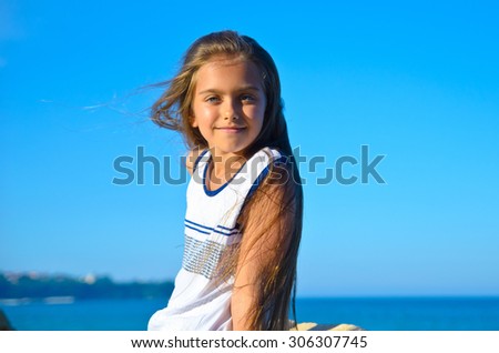 beautiful tanned teen girl against the sea, a girl with long hair. attractive girl in a summer dress after the holidays. Beautiful tourist  teen girl on summer vacation