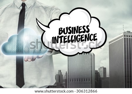 Business intelligence text on cloud computing theme with businessman on cityscape background