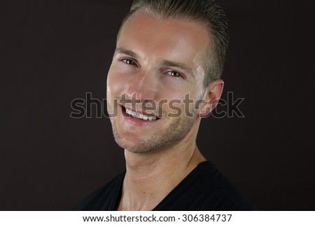 smiling young man over a  brown background