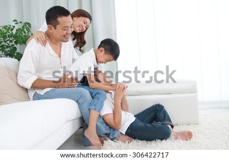 Asian family having fun at home Royalty-Free Stock Photo #306422717