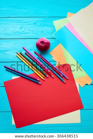 Office and student accessories on blue wooden background. Back to school concept.