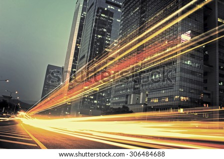 the light trails on the modern building background in city