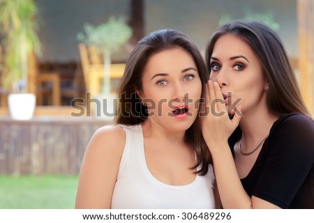 Two Best Friend Girls Whispering a Secret  - Young women sharing gossip and whispering secrets
 Royalty-Free Stock Photo #306489296