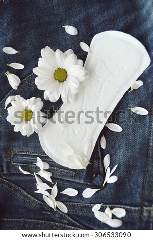 panty liners and tampons on jeans background