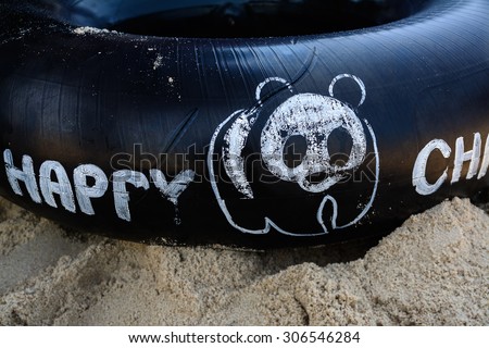 Large inflated inner-tube with Panda on Thailand beach