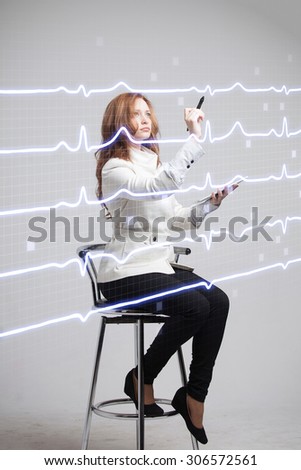 young doctor woman drawing cardiogram in air
